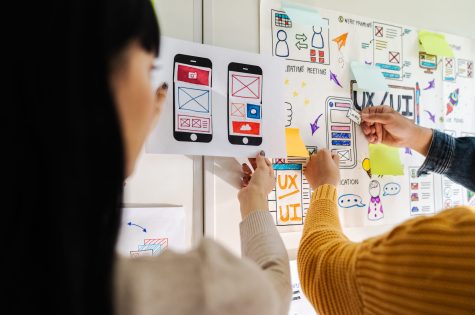 Close up ux developer and ui designer brainstorming interface wireframe design.Creative digital development agency.